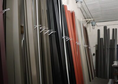Various colored vertical metal sheets stored in a warehouse.