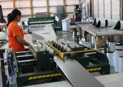 Industrial printing facility with machinery and rolls of materials on tables.