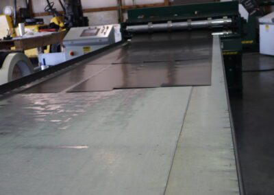 "Industrial workshop with a large format printer and various tools scattered around."